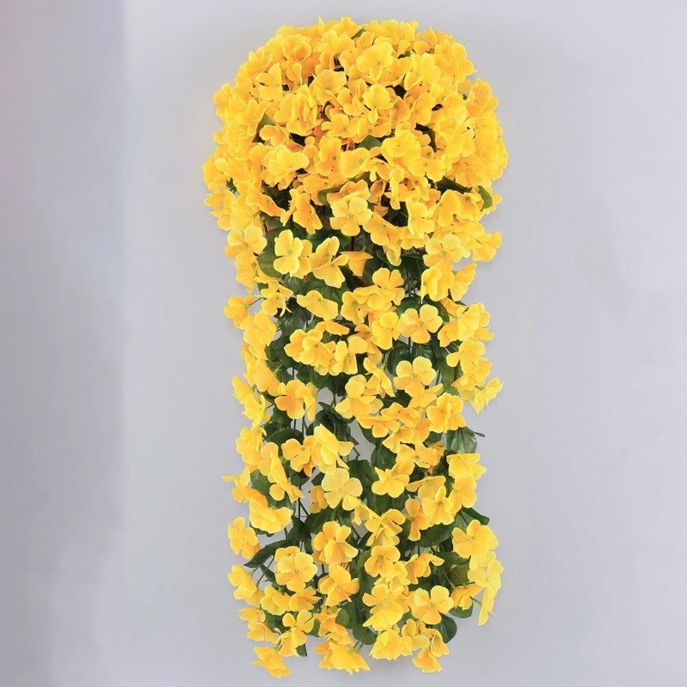 A vertical arrangement of bright yellow artificial violet ivy flowers used as a hanging garland.