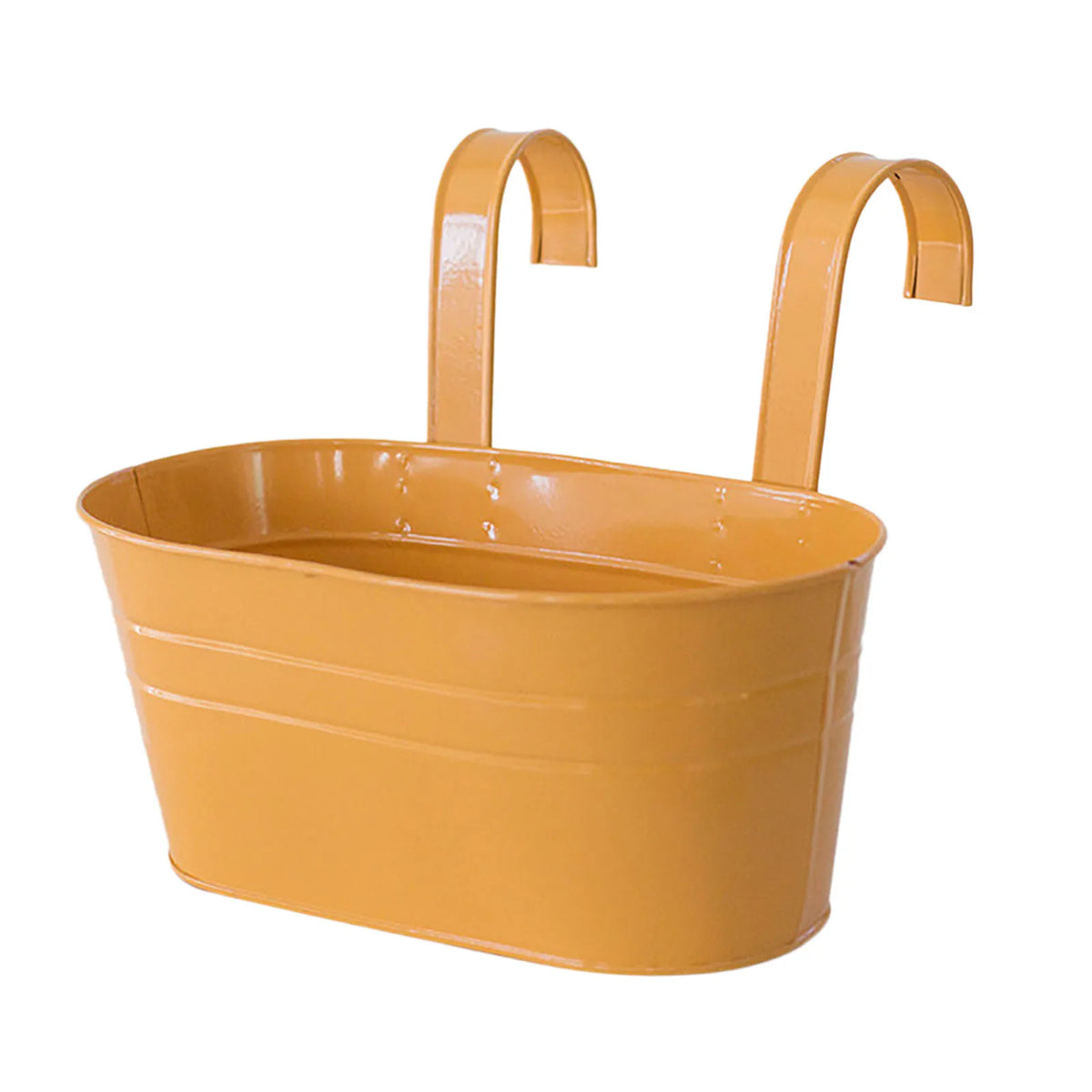 A modern boho metal hanging planter in a mustard yellow color with curved handles.