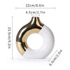 A ceramic flower vase with a gold and white finish, shown from the side.