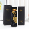 Three black gift boxes with gold foil rose designs and certificates displayed on a white surface.