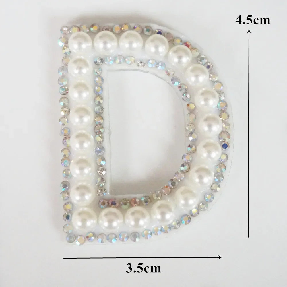 A white pearl letter D patch embellished with colorful rhinestones for clothing
