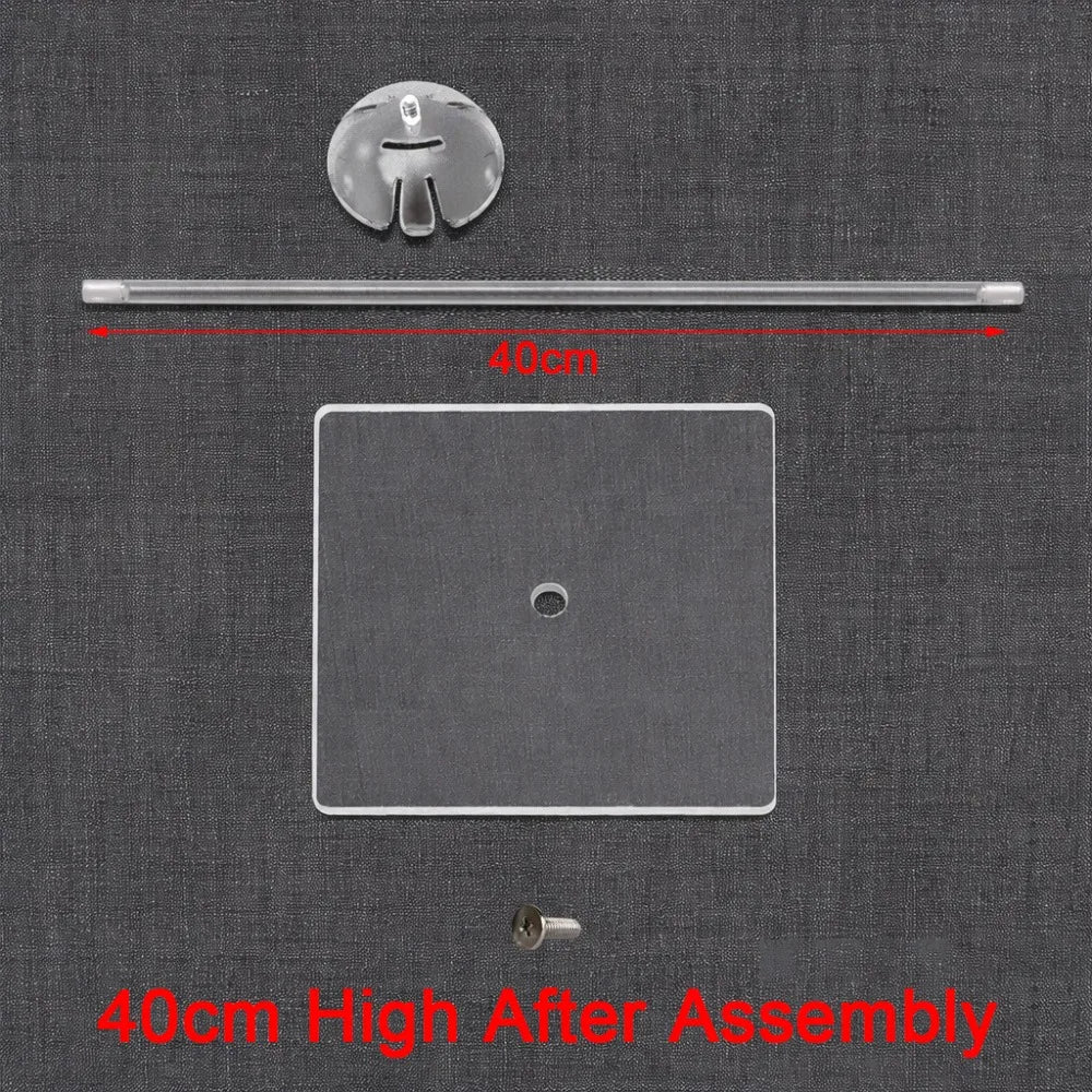 A clear acrylic balloon stand with a rod and base shown on a dark fabric background.