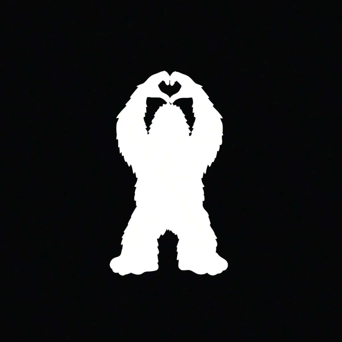 White silhouette of Bigfoot hands forming a heart shape on a black background