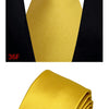 A yellow silk necktie tied in a knot against a black shirt collar.