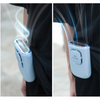 A hand holding a portable multi-use cooling fan emitting a cool mist or vapor.