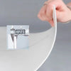 A hand is using a digital measuring tool to check the thickness or dimension of white marble wall tiles.