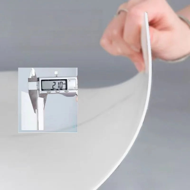 A hand is using a digital measuring tool to check the thickness or dimension of white marble wall tiles.