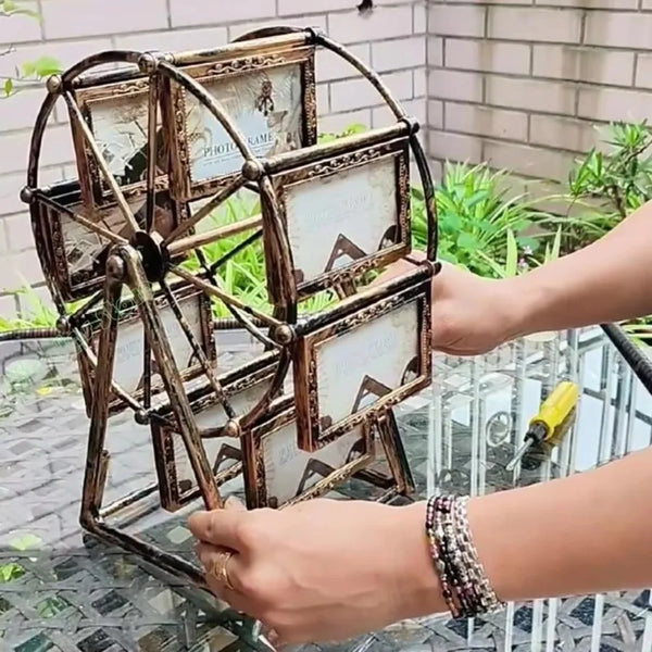 A person is assembling a rotating photo frame with 12 display slots made of dark metal and light-colored paper.