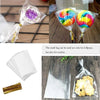 A kit containing 100 lollipop packaging bags with paper sticks and tie closures, some filled with colorful lollipops and othe