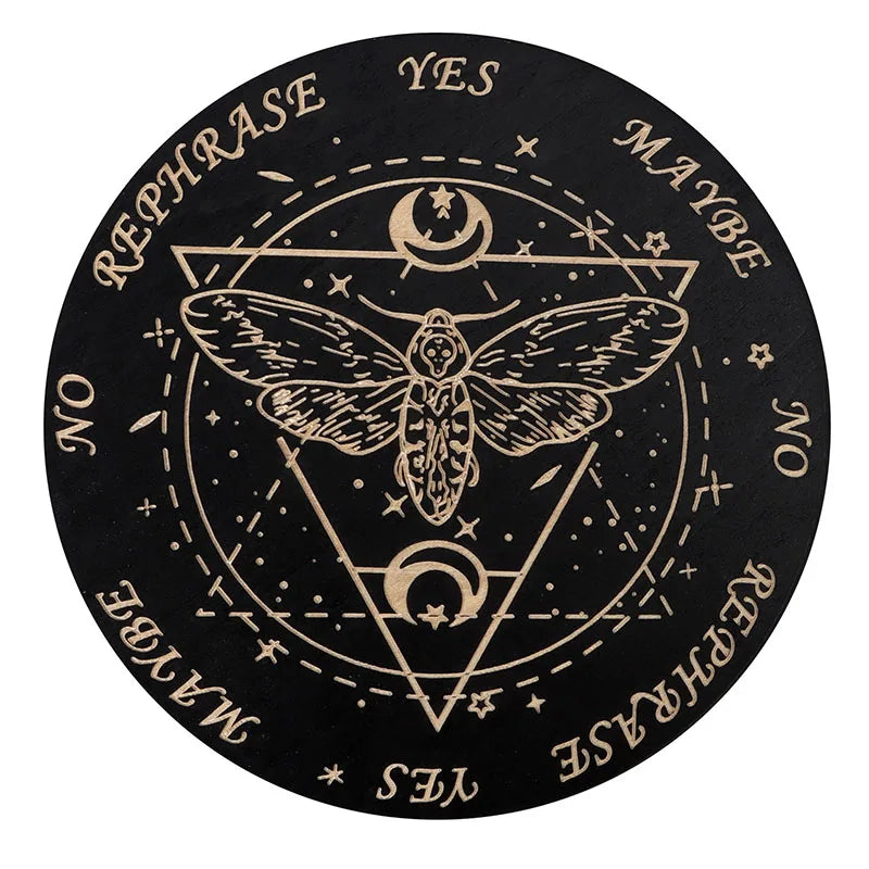 A black wooden divination board featuring a pentagram, a moth, and various yes/maybe symbols around the edge.