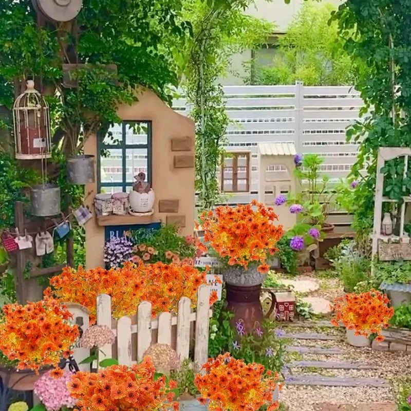 An artificial autumn bouquet featuring vibrant orange and yellow silk flowers displayed outdoors among greenery.