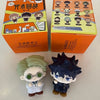 A blind box collectible featuring figures of Gojo and Geto from Jujutsu Kaisen, displayed next to their packaging.