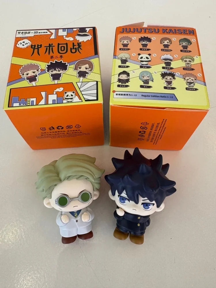 A blind box collectible featuring figures of Gojo and Geto from Jujutsu Kaisen, displayed next to their packaging.