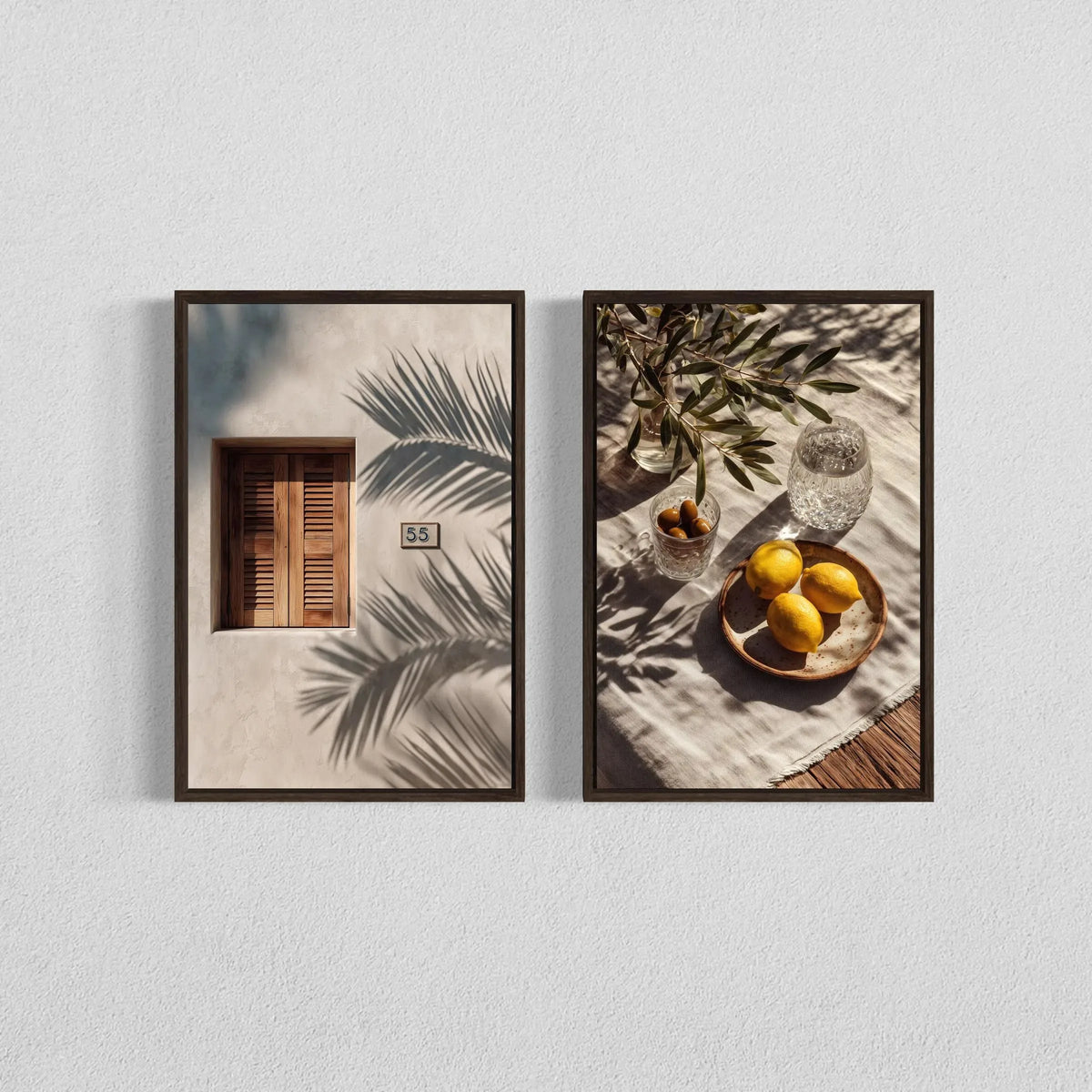 Two framed botanical prints featuring shadows of palm leaves and olive branches on a light background.