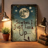 Vintage metal wall decor featuring a quote 'Sometimes I Just Look Up' with a moon and dragonflies.