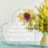 A clear heart-shaped glass frame with a red rose and yellow flowers, featuring a message of love.