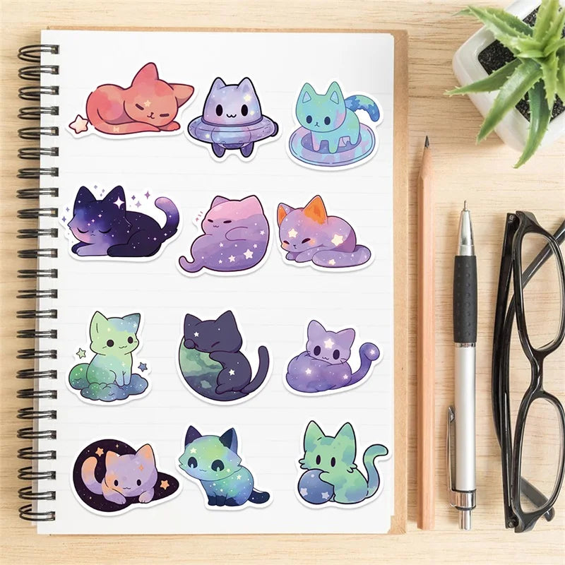 A collection of colorful PVC starry sky cat stickers for scrapbooking displayed in a spiral notebook.