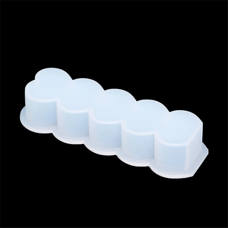 A silicone candle mold kit with two heart-shaped molds arranged in a row against a black background.