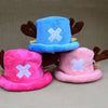 A pair of plush knit hats in blue and pink with white crosses, resembling Tony Tony Chopper.