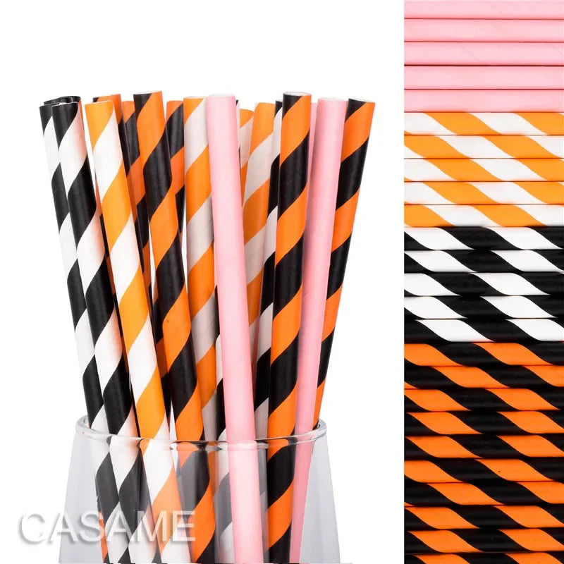 A vertical arrangement of colorful striped and polka dot paper drinking straws in various shades of orange, pink, and black.