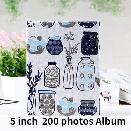 A square album cover featuring a pattern of cartoon animals and objects on a light gray background.