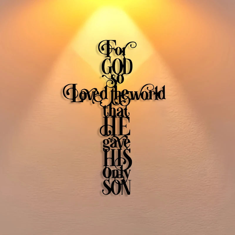 A black iron cross wall art with the quote For God So Loved the world that He gave His only Son, set against a warm, glowing 