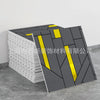 A stack of gray and yellow marble peel-and-stick tile stickers is shown on a gray surface.