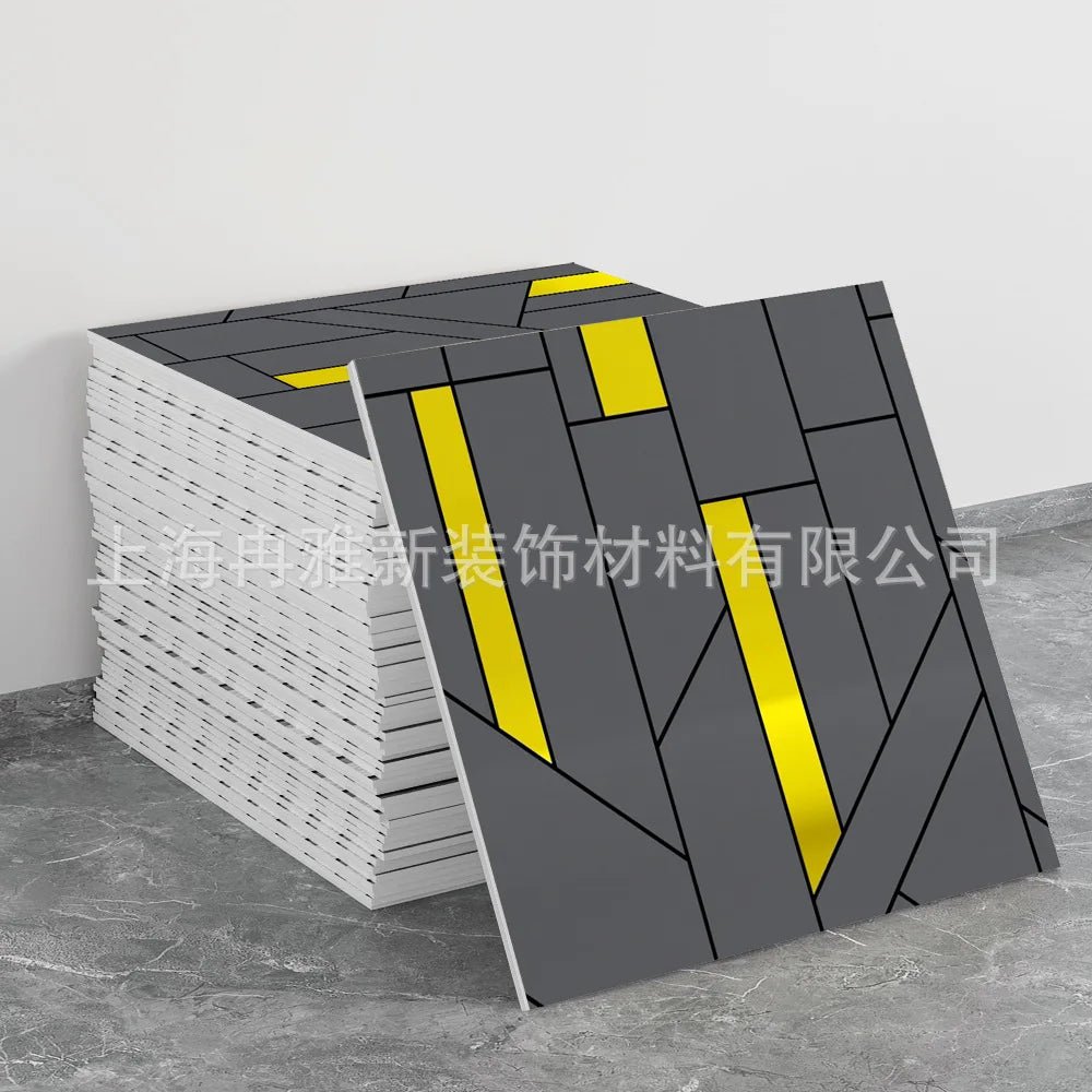 A stack of gray and yellow marble peel-and-stick tile stickers is shown on a gray surface.