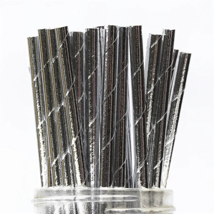 A bundle of 100 colorful striped and polka dot paper drinking straws standing upright.