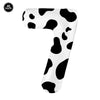 A white foil balloon shaped like the number 9, covered in black cow print spots.