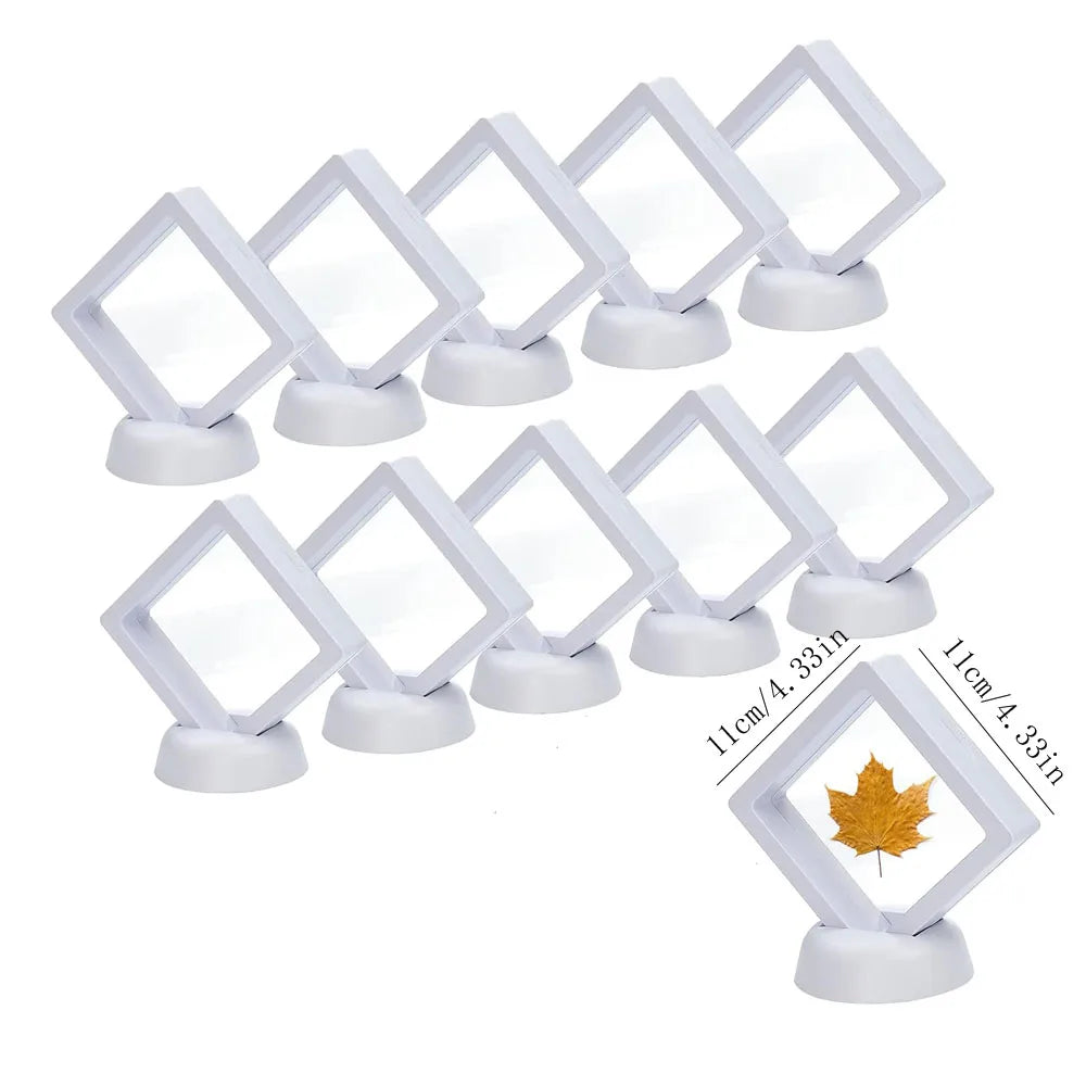 A set of ten white floating shadow box jewelry display frames with clear acrylic panels and white bases.