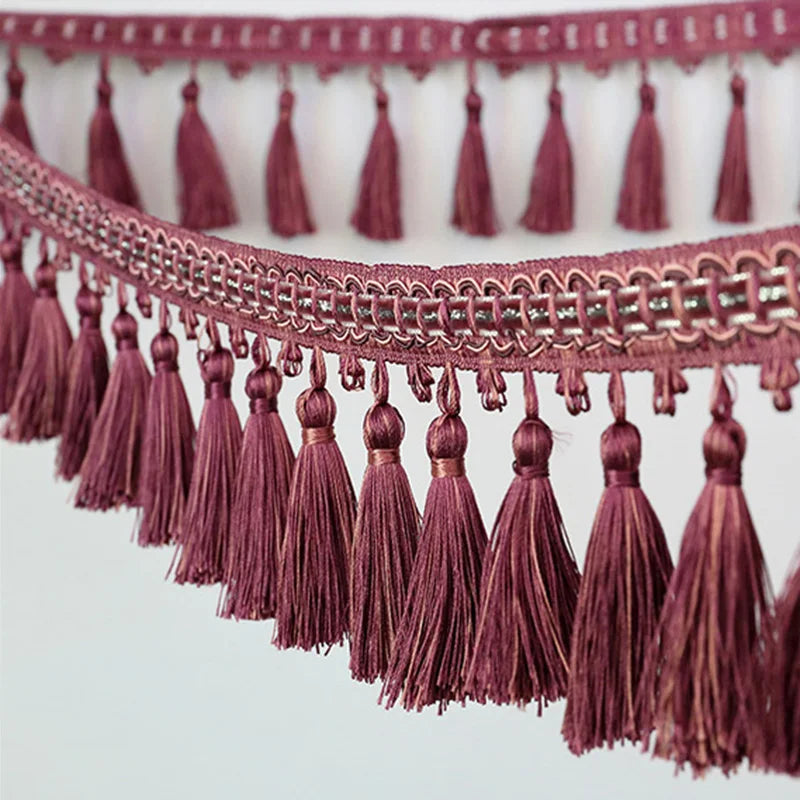 Close-up of a maroon decorative tassel fringe trim used for curtains and DIY projects
