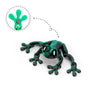 A green articulated 3D printed frog magnet with a movable head, shown next to its detached part.