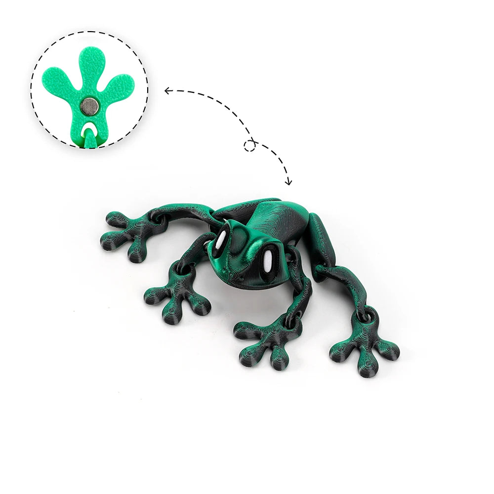 A green articulated 3D printed frog magnet with a movable head, shown next to its detached part.