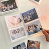 A collection of glossy photos and portraits displayed in clear plastic holders on a white surface.