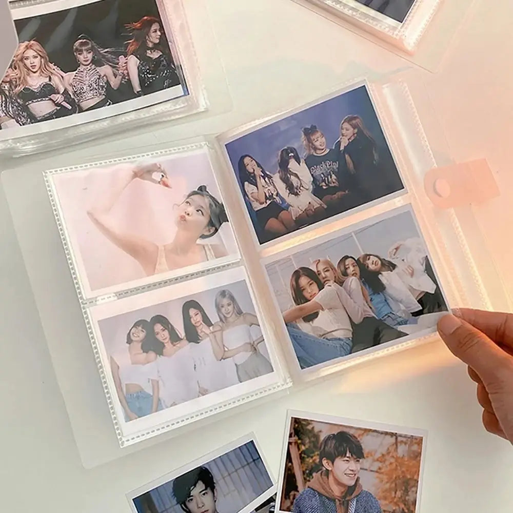 A collection of glossy photos and portraits displayed in clear plastic holders on a white surface.
