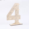 A wooden number display stand shaped like the numeral four, used for serving desserts.
