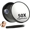 A black magnifying makeup mirror with a suction cup mount and a black handle is shown.