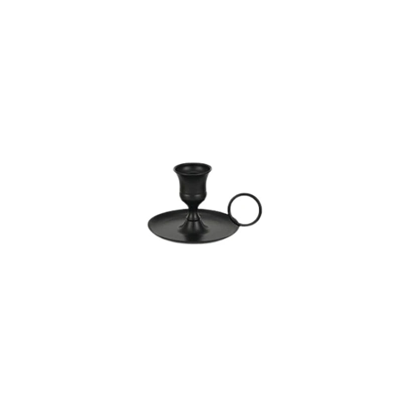 A black artisan metal candle holder with a handle for elegant table settings.