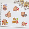 A collection of cute brown bear decals and stickers on a white notepad.