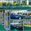 A factory floor showing workers assembling realistic skull figurine sets for Halloween and gothic decor.
