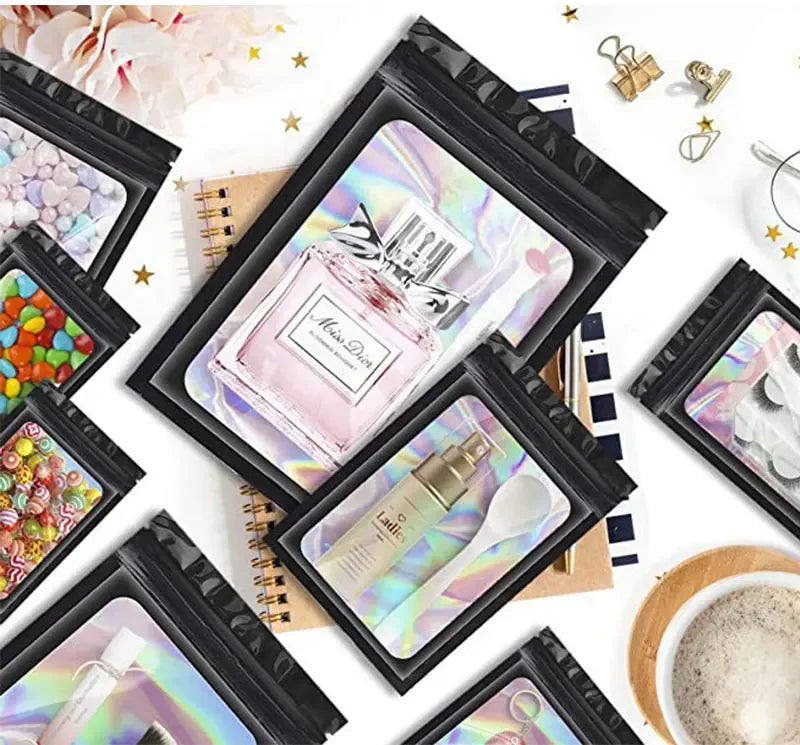 A collection of black holographic ziplock bags for jewelry and small item storage displayed on a white background.
