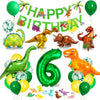 A colorful dinosaur party decoration kit featuring foil balloons, a banner, and a cake topper.