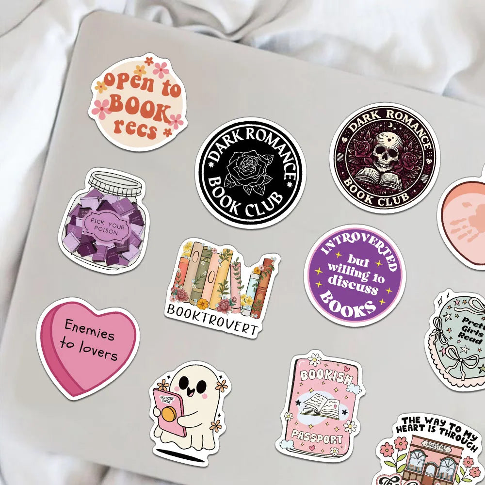 A collection of creative romantic reading stickers on a laptop, featuring themes like dark romance, book club, and enemies to