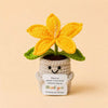 Handcrafted crochet lily flower pot with a yellow flower and a thank you card