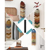 Wall-mounted organizer rack displaying various baseball hats in different colors and shades.