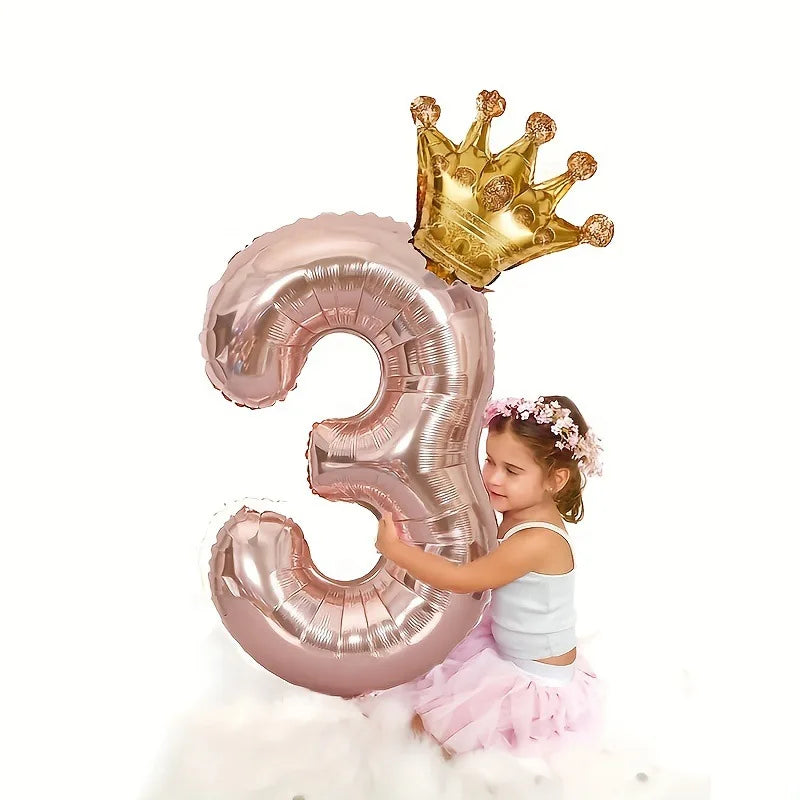 Rose gold foil balloon shaped like the number 3, accompanied by a gold crown.
