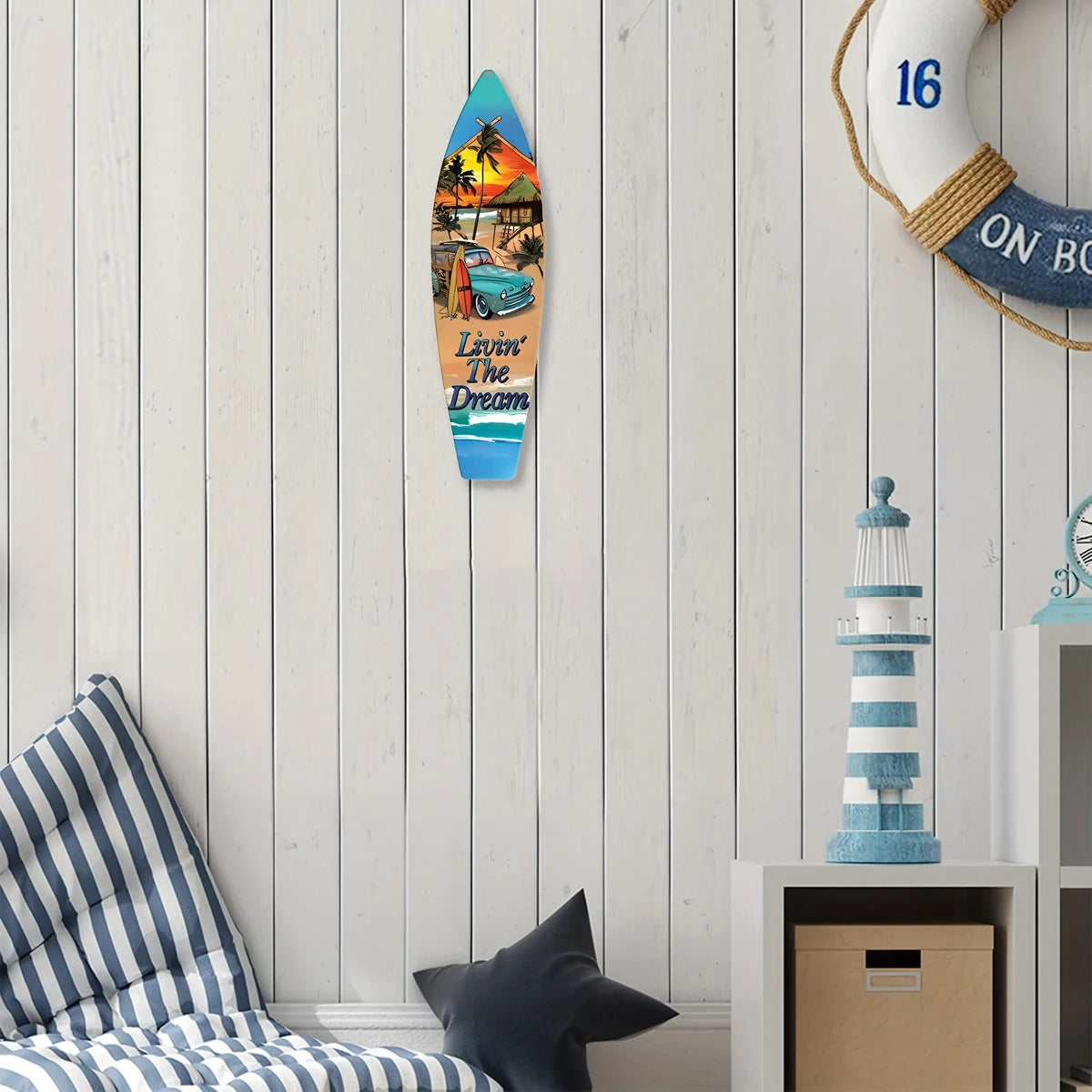A wooden wall decor sign shaped like a surfboard featuring a tropical scene and the text Live in the Dream