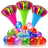A collection of colorful water balloons and a green filler with many bright colored balloons.