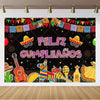 A vibrant Mexican carnival theme backdrop banner featuring colorful bunting, guitars, and festive decorations on a black back